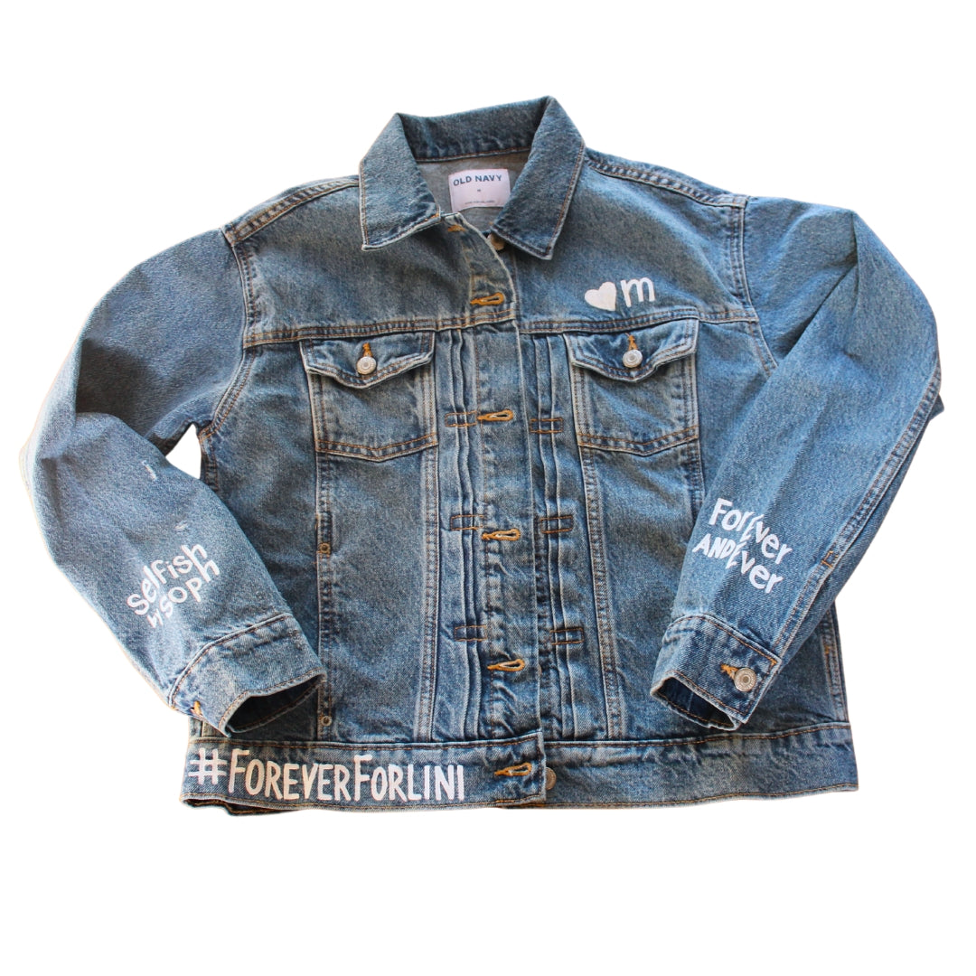Hand-Painted Bridal Denim Jacket featuring delicate flowers, personalized with initials and love quote. Unique and chic fashion for a memorable wedding day. #BridalStyle #WeddingFashion
