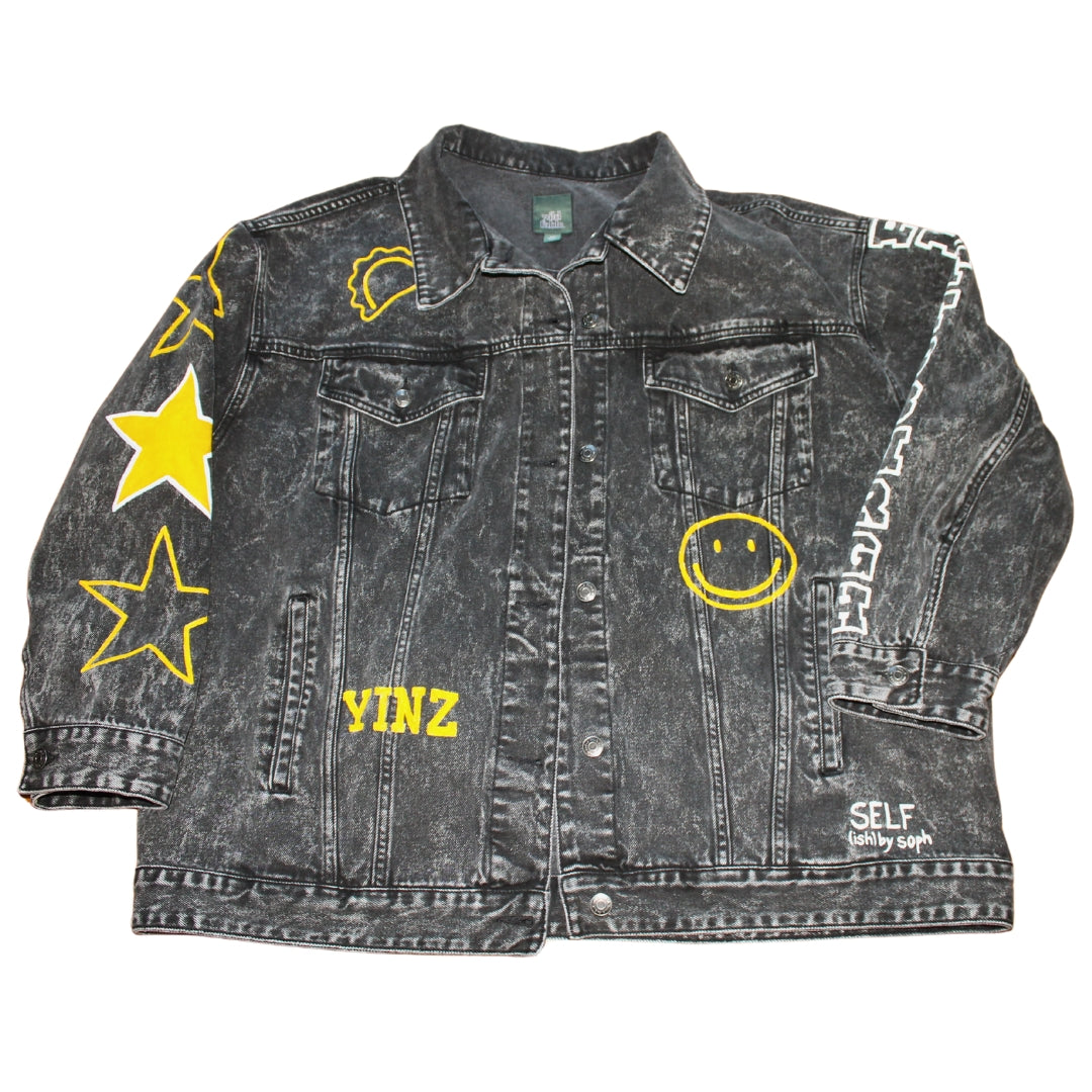 A black denim jacket featuring hand-painted city skyline, stars on sleeves, city name, and symbols for urban flair.