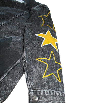 A black denim jacket featuring hand-painted city skyline, stars on sleeves, city name, and symbols for urban flair.